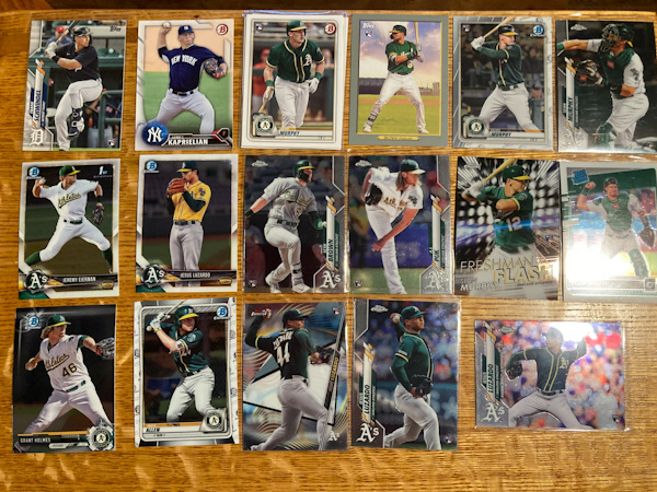 A selection of baseball cards featuring Oakland A's prospects